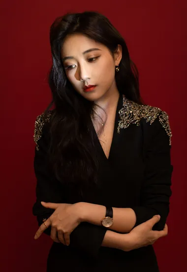 李艺彤红色背景下穿着黑色西装演出服写真图片